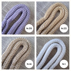 May include: Four spools of cord in different colors: lavender, beige, light beige, and white. The spools are labeled with numbers: Nr.201, Nr.221, Nr.44, and Nr.1.