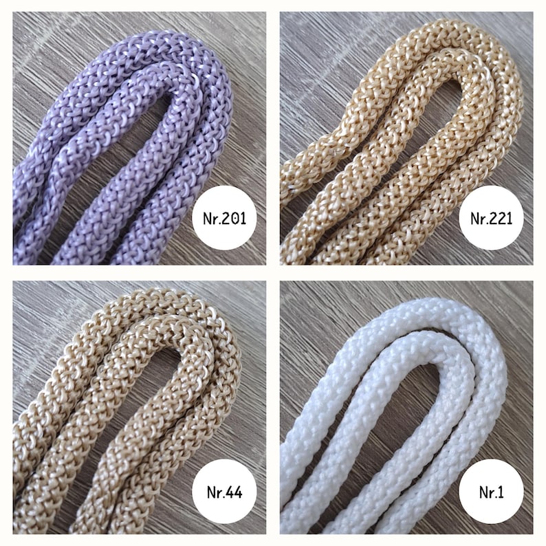 May include: Four spools of cord in different colors: lavender, beige, light beige, and white. The spools are labeled with numbers: Nr.201, Nr.221, Nr.44, and Nr.1.