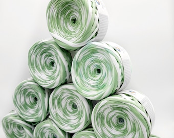 May include: A stack of eight green and white yarn balls, arranged in a pyramid shape. The yarn is a thick, chunky type, perfect for crocheting or knitting.