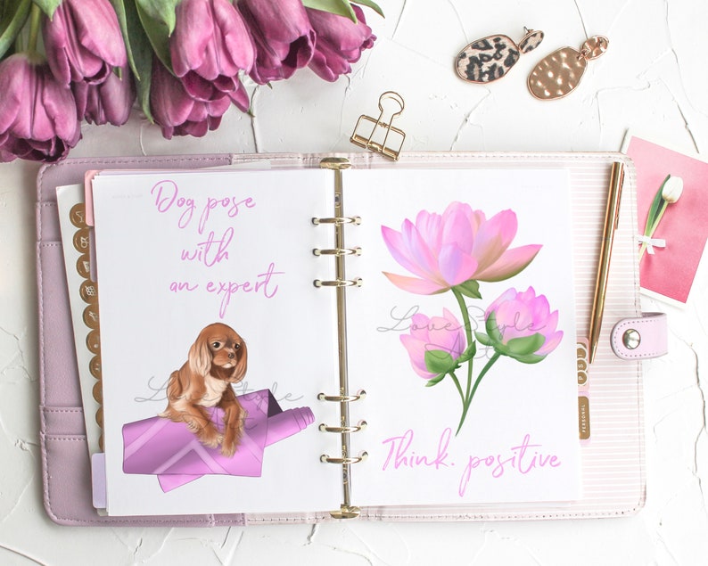 May include: An open planner with two pages. The left page has a pink illustration of a dog on a pink blanket with the text "Dog pose with an expert". The right page has a pink illustration of a flower with the text "Think positive".
