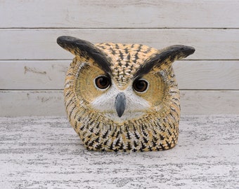 Eagle owl, a wooden sculpture of an owl head.