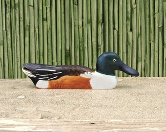 Shoveler, a wooden bird, a sculpture of a duck.