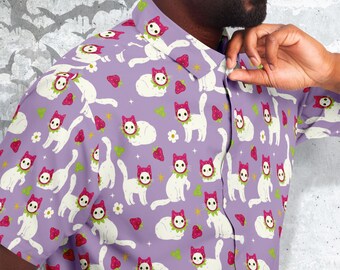 May include: A purple button-down shirt with a white cat wearing a strawberry pattern. The cat is repeated throughout the shirt.