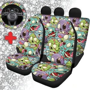 May include: Set of four black car seat covers featuring a colourful zombie pattern. The design includes green, blue, pink and white zombie faces with a variety of expressions.