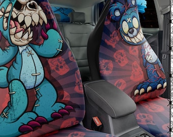 May include: Two car seat covers with a red and black skull pattern. The front seat cover features a blue monster with a stitched-on teddy bear design. The back seat cover features a blue monster with a stitched-on teddy bear design. The text on the image reads "ALL OUR PRODUCTS ARE CUSTOM MADE TO ORDER, AND PRODUCTION TIME IS AROUND 2-8 BUSINESS DAYS + SHIPPING TIME. THOUGH USUALLY PRODUCTION AND SHIPMENT ARE ROCKET FAST, FROM TIME TO TIME THERE CAN BE DELAYS DUE TO THE CURRENT WORLDWIDE SITUATION. NCO"