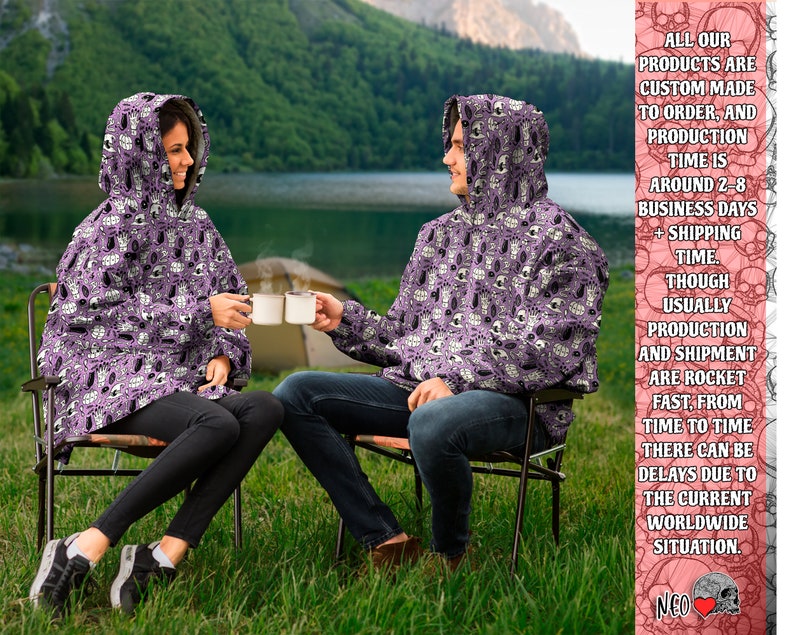 May include: Two people wearing purple hooded sweatshirts with a white and black skull pattern are sitting on chairs outdoors. The sweatshirts have a hood and a pouch pocket. The text on the right side of the image reads: "ALL OUR PRODUCTS ARE CUSTOM MADE TO ORDER, AND PRODUCTION TIME IS AROUND 2-8 BUSINESS DAYS + SHIPPING TIME. THOUGH USUALLY PRODUCTION AND SHIPMENT ARE ROCKET FAST, FROM TIME TO TIME THERE CAN BE DELAYS DUE TO THE CURRENT WORLDWIDE SITUATION. NEO"