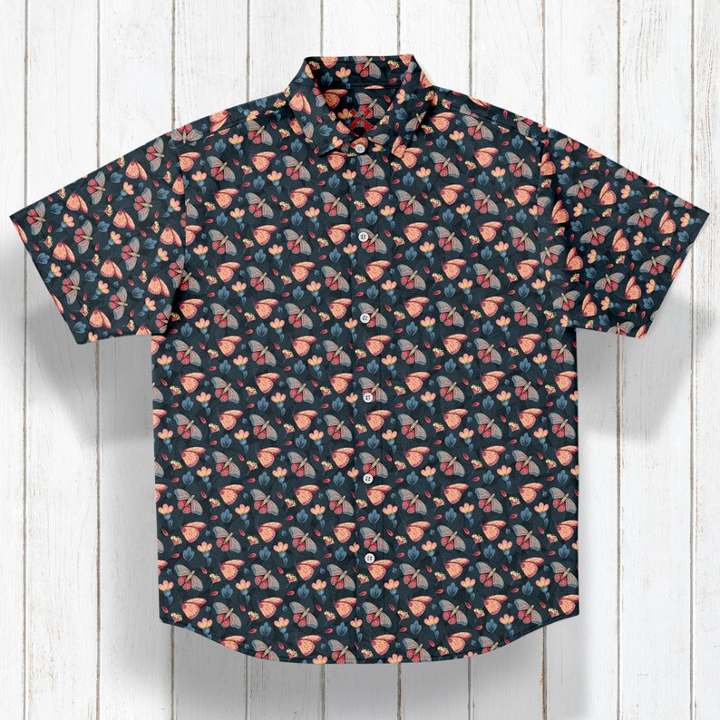May include: A dark blue short-sleeved button-up shirt with a repeating pattern of pink and orange butterflies on a dark blue background.