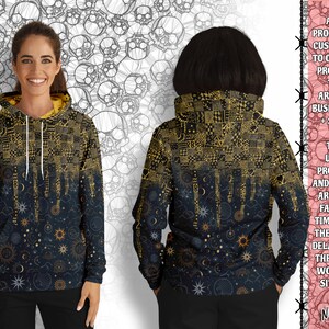 May include: A black hoodie with a gold and black patterned design. The pattern features a celestial theme with stars, moons, and suns. The hoodie has a zipper and a hood.