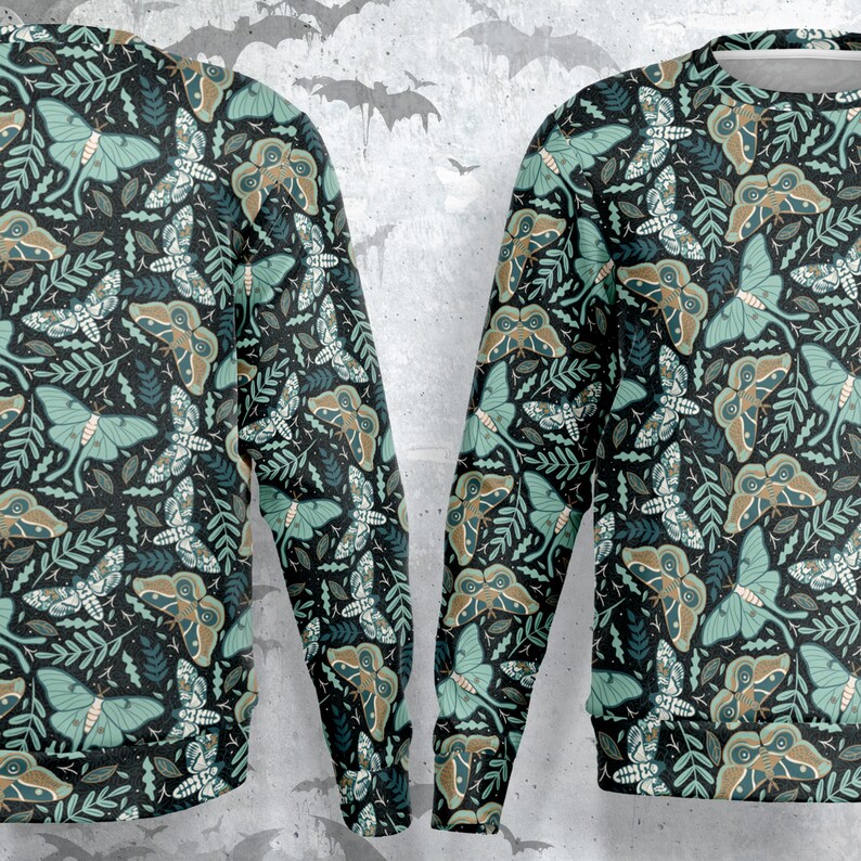May include: A black sweatshirt with a repeating pattern of green moths and leaves. The moths have brown and green wings and the leaves are a dark green.