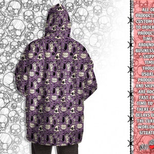 May include: Purple hooded sweatshirt with a repeating pattern of black cats, pumpkins, hands, and other Halloween-themed imagery.