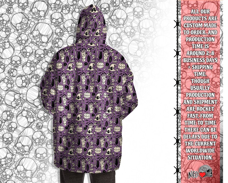 May include: Purple hooded sweatshirt with a repeating pattern of black cats, pumpkins, hands, and other Halloween-themed imagery.