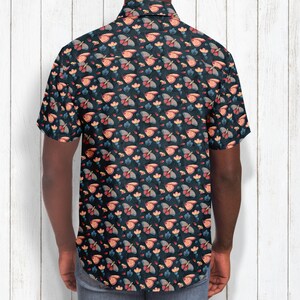 May include: A short-sleeved button-down shirt with a dark blue background and a repeating pattern of colorful butterflies and flowers.