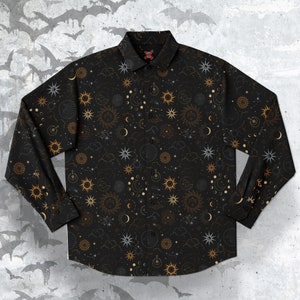 May include: A black long-sleeved button-down shirt with a celestial pattern. The pattern features gold stars, moons, and suns on a black background.