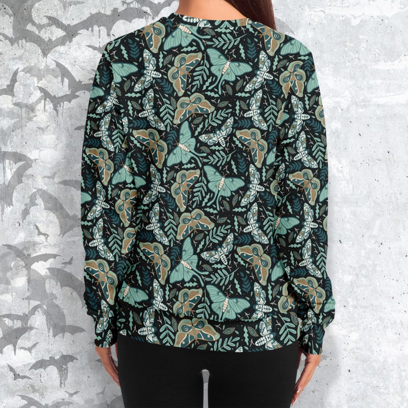 May include: A black sweatshirt with a repeating pattern of green and brown moths on a dark background.