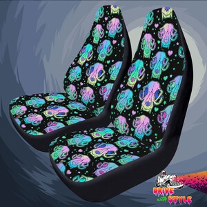 May include: Two black car seat covers with a colorful skull and heart pattern. The pattern features pastel pink, blue, green, and yellow colors on a black background.