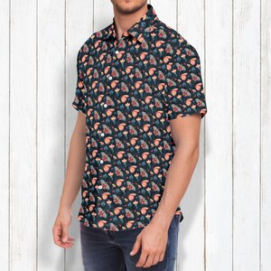 May include: A short-sleeved button-down shirt with a dark blue background and a repeating pattern of colorful butterflies and flowers.
