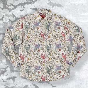 May include: A long-sleeved button-up shirt with a white background and a repeating pattern of colourful dragons and vines. The dragons are in shades of red, blue, green, and purple.