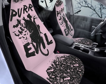 May include: A pair of pink car seat covers with a black cat and the text "Purr Evil". The covers feature a black and white pattern of various spooky Halloween-themed items.