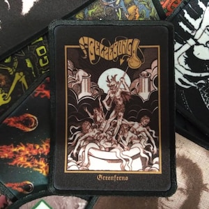 May include: Black and white patch with a graphic of a demon holding a goblet. The demon is surrounded by other figures and the text "Greenferno" is at the bottom.