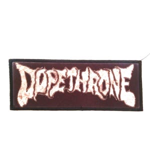 May include: A brown embroidered patch with the white text "DOPE THRONE" in a gothic font.
