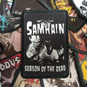 May include: Black and white embroidered patch with the band name "SAMHAIN" and the text "SEASON OF THE DEAD".