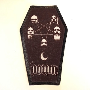 May include: A black and white embroidered patch shaped like a coffin with the band name "DOWN" in white lettering. The patch features a pentagram with five white faces of the band members.