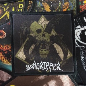 May include: Black and green embroidered patch with a skull with horns and the text "Gorgoroth" in a stylized font.