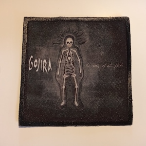 May include: A black and white embroidered patch featuring the band name "GOJIRA" and the album title "The Way of All Flesh". The patch depicts a skeleton with a heart and intestines.