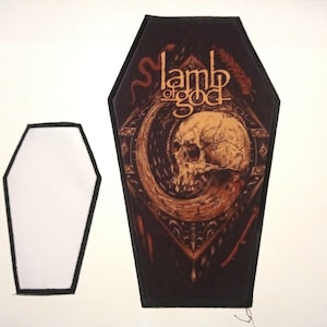 May include: A black and brown embroidered patch shaped like a coffin with the words "Lamb of God" and a skull with a snake wrapped around it.