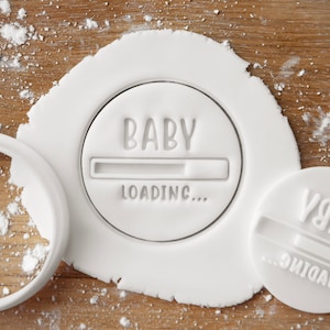 May include: White plastic cookie cutter with a round shape and the text "BABY LOADING..." inside. The progress bar is partially filled.