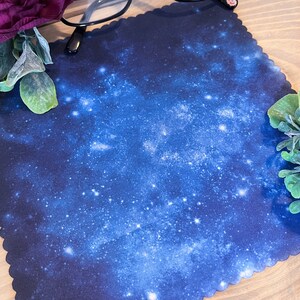 May include: A blue microfiber cleaning cloth with a galaxy print. The cloth is perfect for cleaning glasses, screens, and other delicate surfaces.