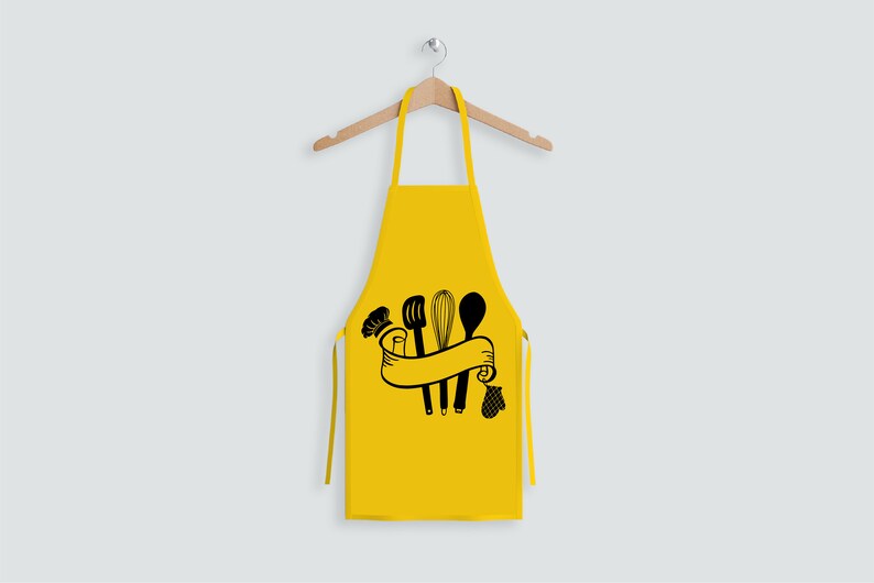 May include: A yellow kitchen apron with a black design of kitchen utensils, a chef's hat, and a banner.