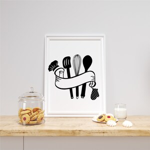 May include: Black and white kitchen utensil design with a chef's hat, a whisk, a spatula, a wooden spoon, and a banner. The design is on a white background.