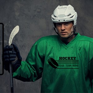 May include: A hockey player in a green jersey and white helmet, holding a hockey stick. The jersey features the word "HOCKEY" and "YOUR TEAM NAME", plus a hockey puck graphic. File format options are also shown.