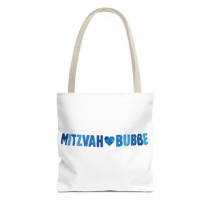 May include: White tote bag with beige handles. The bag features the text "MITZVAH BUBBE" in blue, with a blue heart graphic. The bag is designed for carrying items.