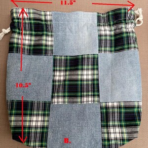 May include: A patchwork drawstring bag, 11.5 inches wide and 10.5 inches tall, featuring denim and green, black, and white plaid fabric squares. The bag has a white drawstring closure and the letter "B." in red.