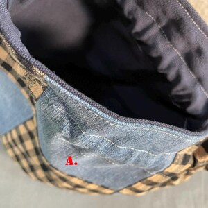 May include: Close-up of a patchwork bag with denim, blue, and tan gingham fabric. The bag's interior is a solid dark blue. The letter "A" is visible on the bag.