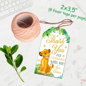 May include: A thank you favor tag with a jungle theme. The tag features a cartoon lion cub from the Lion King movie, green leaves, and the text "Thank You for Celebrating with Me! Love, Connor". The tag is 2 inches by 3.5 inches and comes in a pack of 8.