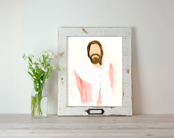 May include: A watercolor painting of Jesus Christ in a pink robe and white shawl. The painting is framed in a white distressed wood frame.