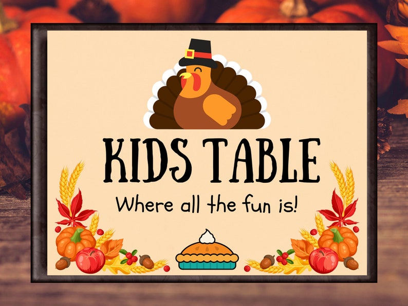 Thanksgiving kids table centerpiece sign that says "Kids Table, Where all the fun is," with a cartoon turkey on top with a pilgrims hat on