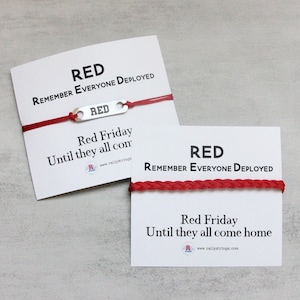 May include: Two red bracelets with silver charms that say "RED" and the text "RED REMEMBER EVERYONE DEPLOYED Red Friday Until they all come home www.rallystrings.com"