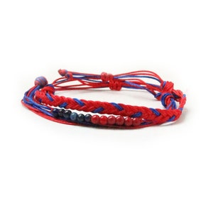May include: Red and blue braided bracelet with small red and blue beads.