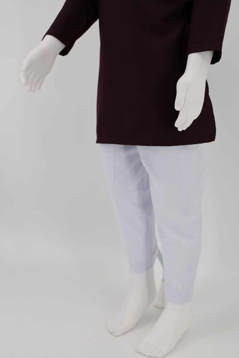 May include: A maroon long-sleeved shirt with white pants. The shirt has a simple design and the pants are plain.