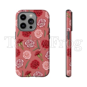 May include: A phone case with a floral pattern featuring red and pink carnations and green leaves on a dusty rose background. The case has a glossy finish and the text "Tacky Frog" is visible.