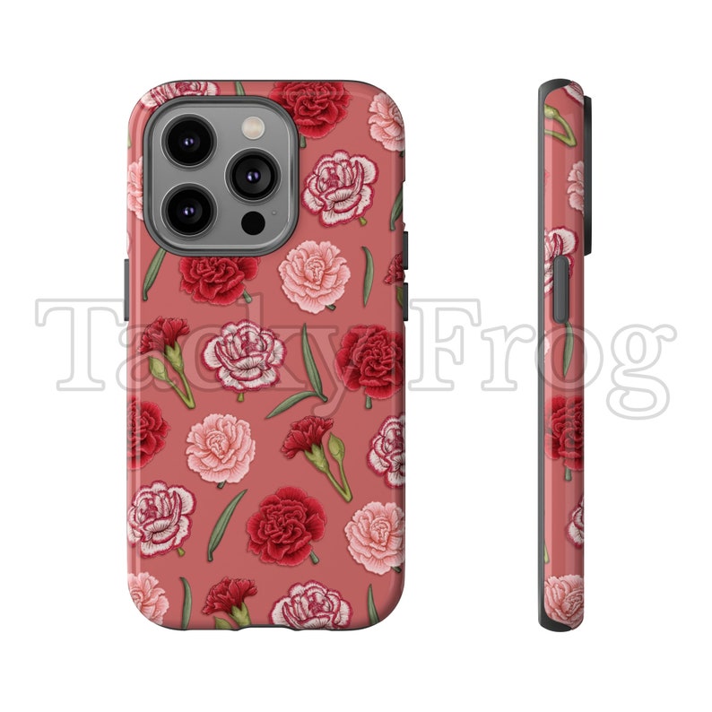 May include: A phone case with a floral pattern featuring red and pink carnations and green leaves on a dusty rose background. The case has a glossy finish and the text "Tacky Frog" is visible.