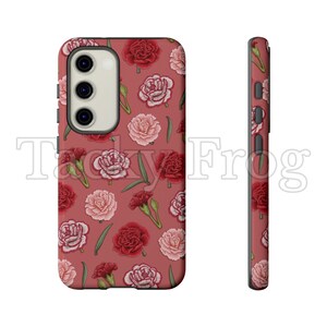 May include: A phone case with a floral pattern of red and pink carnations on a dusty rose background. The case has a camera cutout and side buttons. The text "Tacky Frog" is visible in the background.