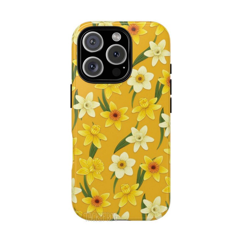 May include: A yellow phone case featuring a pattern of yellow and white daffodils with green leaves. The case has a glossy finish and a black camera module. The text "TACKYFROG" is printed at the bottom.