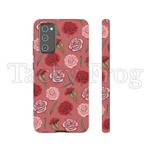 May include: A phone case with a floral pattern featuring red and pink carnations and green leaves on a reddish-brown background. The case has a camera cutout and a matching side view.