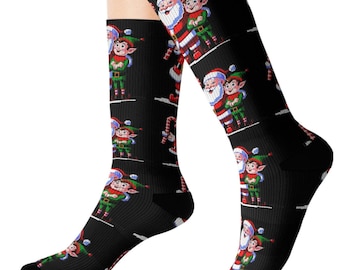 May include: A pair of black socks with a repeating pattern of Santa Claus and an elf in pixelated graphics. The socks are shown on a model's legs.