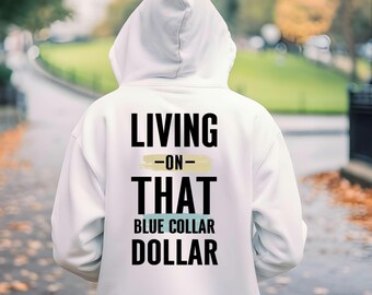 May include: A white hooded sweatshirt with the text "LIVING -ON- THAT BLUE COLLAR DOLLAR" printed on the back in black. The text has a yellow and blue color block design. The person is walking on a sidewalk.